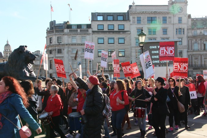 The Million Women Rise march arrived in Trafalgar Square just as the last Time to Act protester passed by. They too had many mass-produced placards.