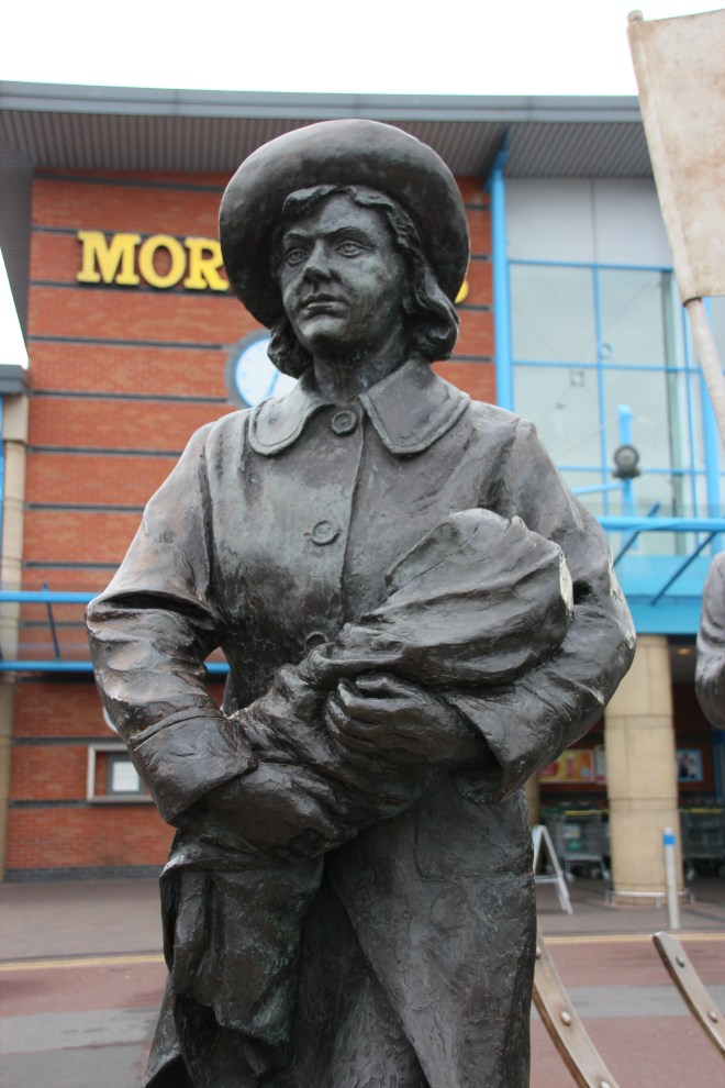 The female marcher in the Spirit of Jarrow carrying a bundle that is probably a baby. 
